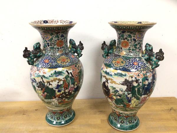 A pair of 20thc Chinese vases of baluster form in famille vert pattern, with lion handles, seal