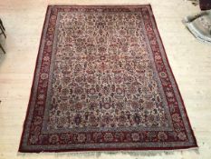 A North West Persian design rug with foliate motif field within border with multiple flowerheads, (