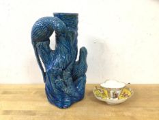 A vase in the form of a tree trunk with two birds having blue glaze, (25cm h) and a French teacup