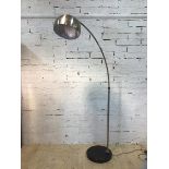 An arched standard lamp the polished dome shade with perforated top on circular marble base, (