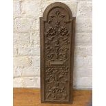 A Mahogany wall panel with domed top and carved foliate decoration, (72cm x 24cm)