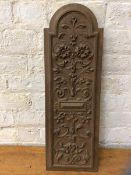 A Mahogany wall panel with domed top and carved foliate decoration, (72cm x 24cm)