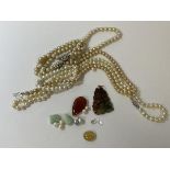 A two tone stone pendant depicting dragon and pearl on yellow metal mount, (6cm), loose pearls,