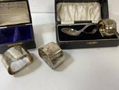 A pair of silver napkin rings, Birmingham, in original box, a silver napkin ring and baby spoon,