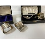 A pair of silver napkin rings, Birmingham, in original box, a silver napkin ring and baby spoon,