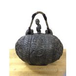 An African water carrier of ovoid form, having carved exterior with foliate design and scorpion to