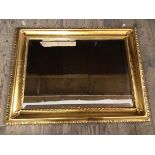 A modern bevelled wall mirror with gilt composition frame (67cm x 87cm)