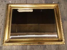 A modern bevelled wall mirror with gilt composition frame (67cm x 87cm)