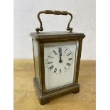 A brass and four glass carriage clock, roman numerals, (14cm h including handle)