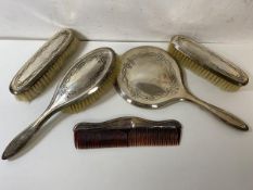 A silver backed vanity set, Birmingham, all engraved with ribbon and floral decoration, (mirror
