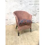 A vintage Lloyd Loom style chair with pink painted back and arms, drop in cushion (68cm x 55cm x