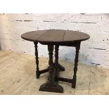 A 19thc gate leg occasional table the oak oval top on turned supports on trestle base