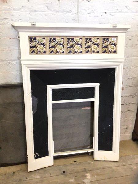 A late 19thc early 20thc fire surround the white painted iron with five floral tiles to frieze