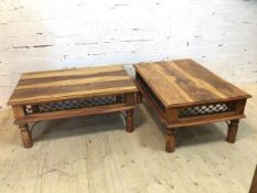 A pair of Indonesian hardwood coffee tables the moulded rectangular tops over metal work friezes