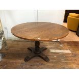 An oak circular pedestal table on turned supports, (73cm x 111cm)