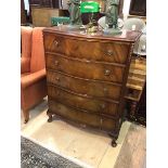 A reproduction Georgian style serpentine fronted chest of drawers with moulded top over five drawers