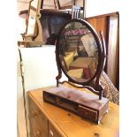 An Edwardian dressing table mirror the oval mirror on rectangular base lacking two drawers,