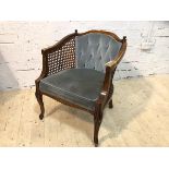 A reproduction Bergere with buttoned back, arms over caned sides, upholstered stuffed seats on