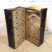 A 1920's steamer trunk wardrobe the rivetted metal bound trunk with domed top and leather carrying