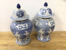A pair of blue and white Chinese lidded baluster shapes vases, (26cm h), blue seal marks to base