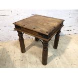 An Indonesian hardwood and metal bound side table the square top with moulded edge on turned