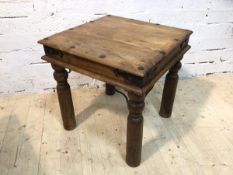 An Indonesian hardwood and metal bound side table the square top with moulded edge on turned
