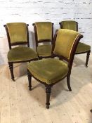 A set of four mid 19th century mahogany side chairs with scrolled backs having moulded edges on