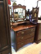 An Edwardian mahogany dressing table the hinged mirror flanked by a pierced and shelf supports