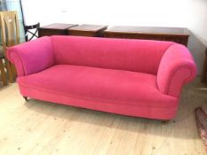 A Chesterfield sofa in pink upholstery on turned front supports terminating in castors, (71cm x
