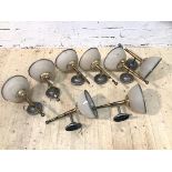 A group of eight wall lights with tapering supports with frosted glass shades having metal rims, (