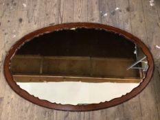An oval wall mirror with moulded and beaded edge, (65cm x 106cm)