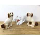 A pair of Staffordshire spaniels, (26cm h) and a novelty teapot in the form of a cat (3)