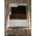 A modern wall mirror, the rectangular bevelled glass within a moulded and dentil detail silvered