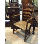 A 19thc elm ladder back open arm chair the ladderbacks with arched centres on curved arms on