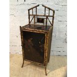 A cane and lacquered panel side cabinet the architectural super structure with lacquered and gilt
