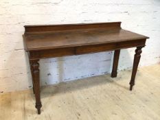 A mid 19thc oak serving table with galleried back, single frieze drawer to centre on turned front
