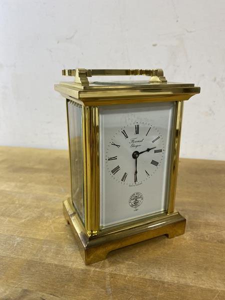 A brass and glass carriage clock, the dial inscribed Forrest, Glasgow with Glasgow Golf Club logo to