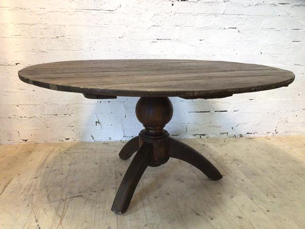A circular French kitchen table on baluster shaped pedestal with arched tripod supports, (73cm h x