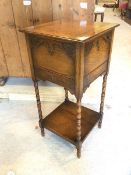 An early 20thc oak pot cupboard the hinged top over blind fret work detailed panels to sides