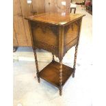 An early 20thc oak pot cupboard the hinged top over blind fret work detailed panels to sides