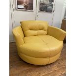 An oversized contemporary circular swivel lounge chair upholstered in yellow leather (84cm 130cm x