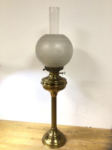 An early 20thc brass gas lamp with frosted shade on column stem base, (76cm h including glass)