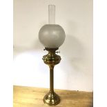 An early 20thc brass gas lamp with frosted shade on column stem base, (76cm h including glass)