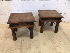 A pair of Indonesian hardwood metal bound side tables, the square moulded tops on turned supports