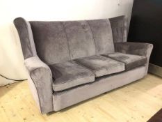 A contemporary grey sofa with wing back high back, on castors, (97cm x 190cm x 97cm)