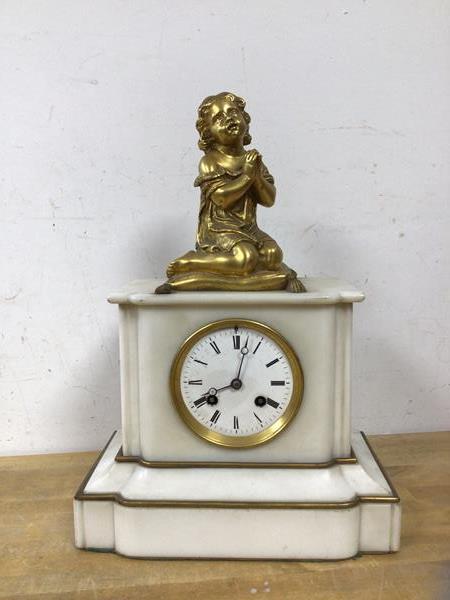A late 19th early 20thc French mantel clock with gilt metal figure of girl praying on pillow,