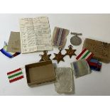 A group of four WWII medals including the Atlantic Star, the Italy Star, the 1939-45 star, and a war