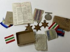 A group of four WWII medals including the Atlantic Star, the Italy Star, the 1939-45 star, and a war