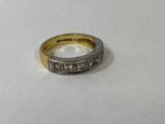 A gold half eternity ring with seven diamonds, size N, weighs 6.82 grammes