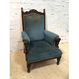 A Victorian oak library armchair with moulded arched crest rail over upholstered back, arms and seat